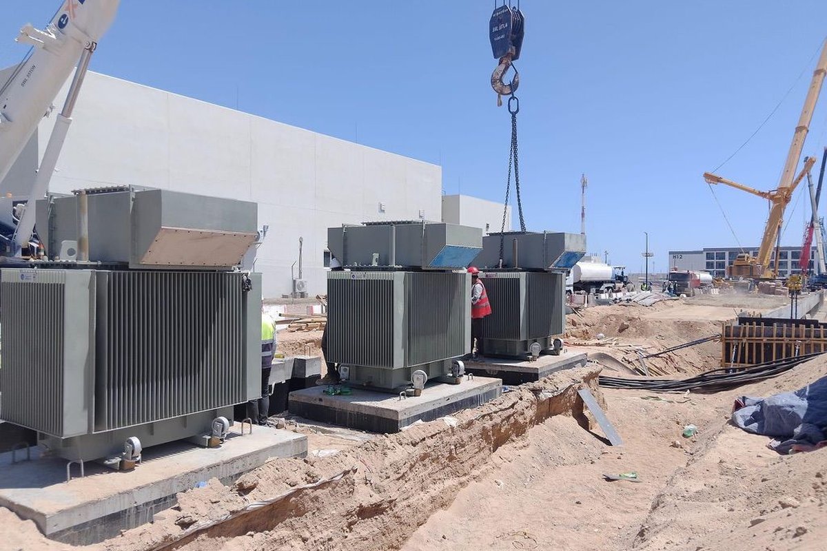 TEMCO transformer installation at a remote desert site, crane positioning large electrical equipment