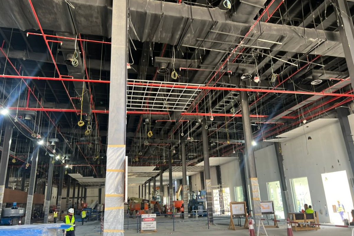 TEMCO NEOM NC1 Central Amenities interior, large building under construction with red fire-suppression pipework